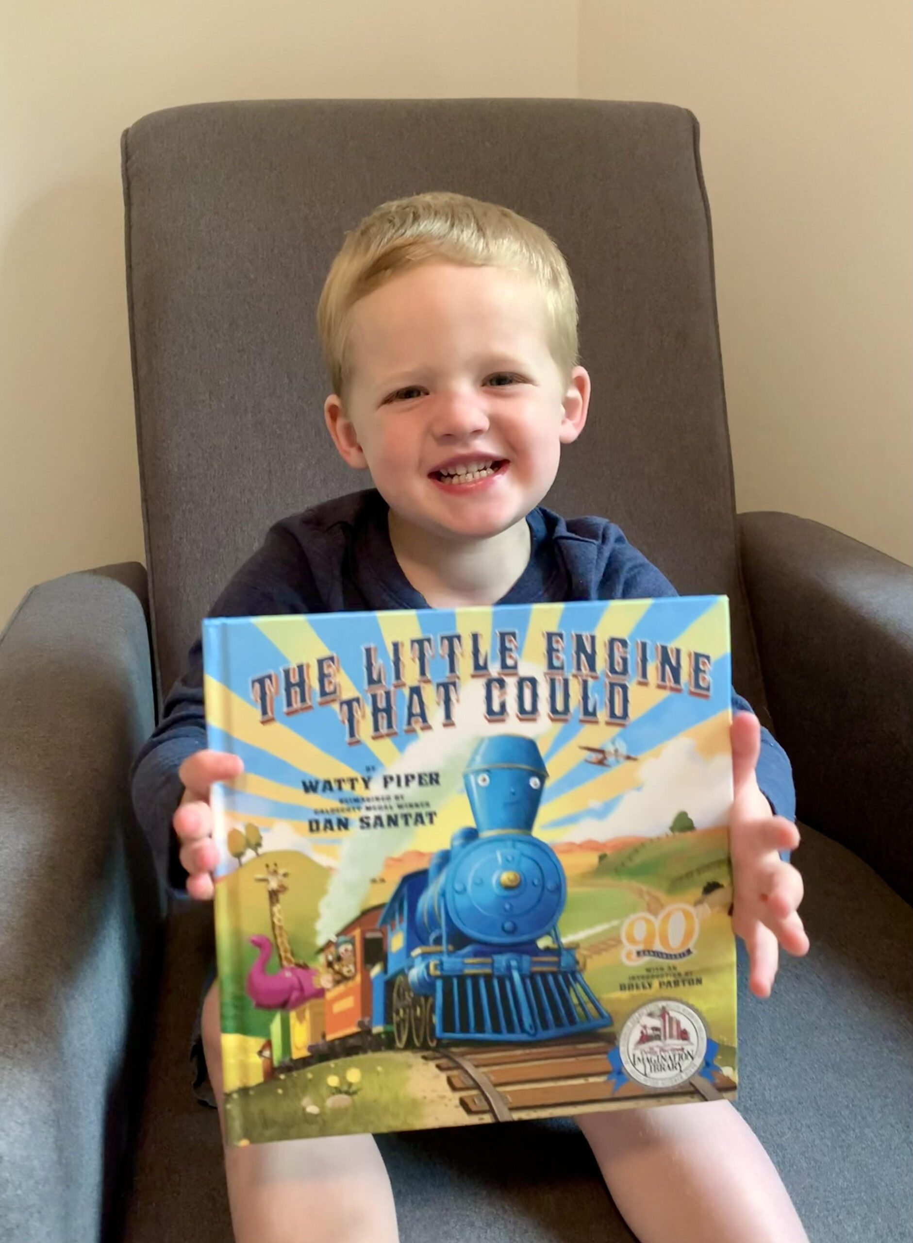 image of a young boy holding a book