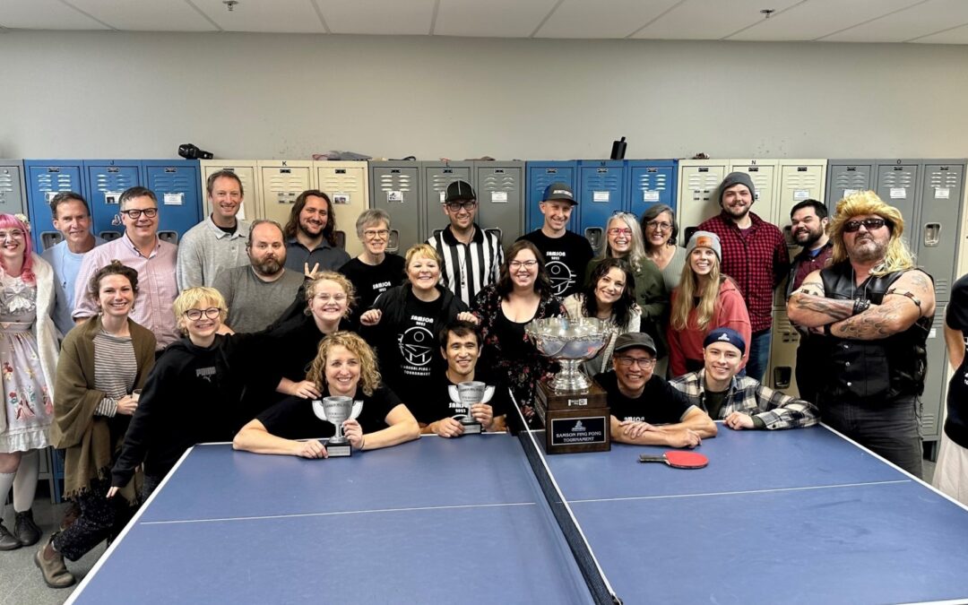 ground of Samson Rope employees posing for a picture after ping pong tournament