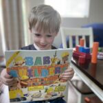 Local child with DPIL book